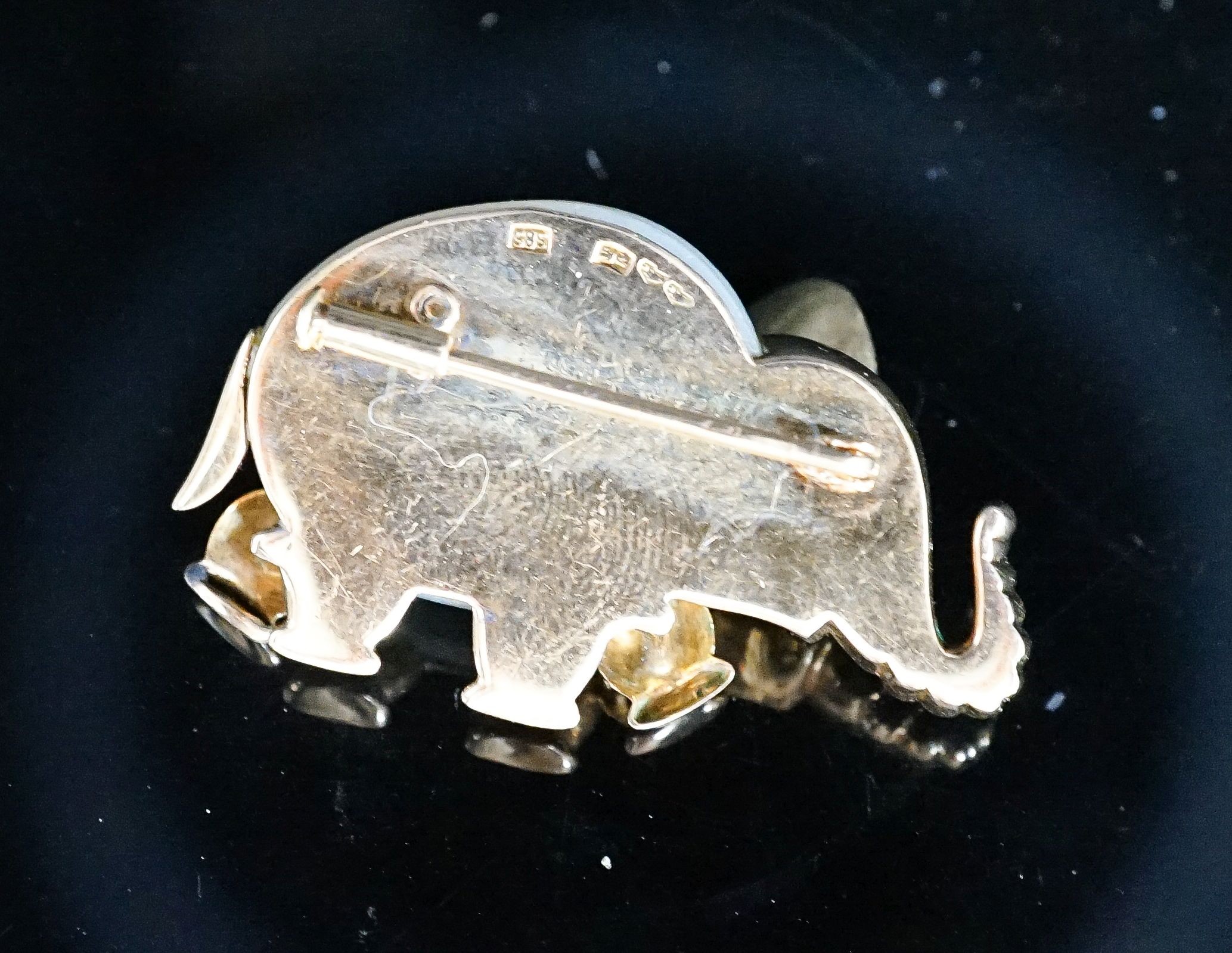 A 20th century Viennese 585 yellow metal, mother of pearl and ruby chip set brooch, modelled as an elephant, 35mm, gross weight 12.7 grams.